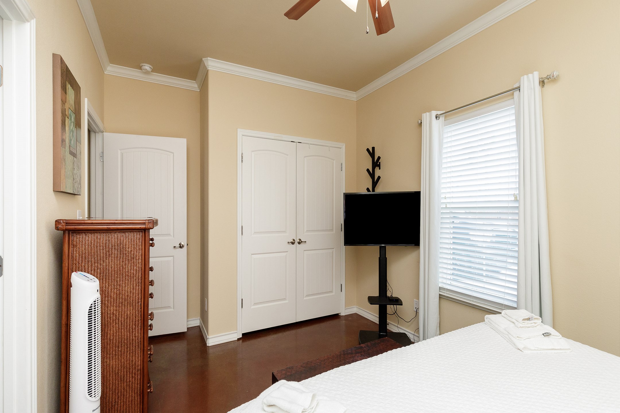 Master bedroom with king size bed, private bathroom, and TV