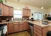 Fully equipped kitchen with stainless steel appliances and ample storage space 