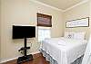 Second bedroom with queen bed and twin over twin size bunk bed with flat screen TV