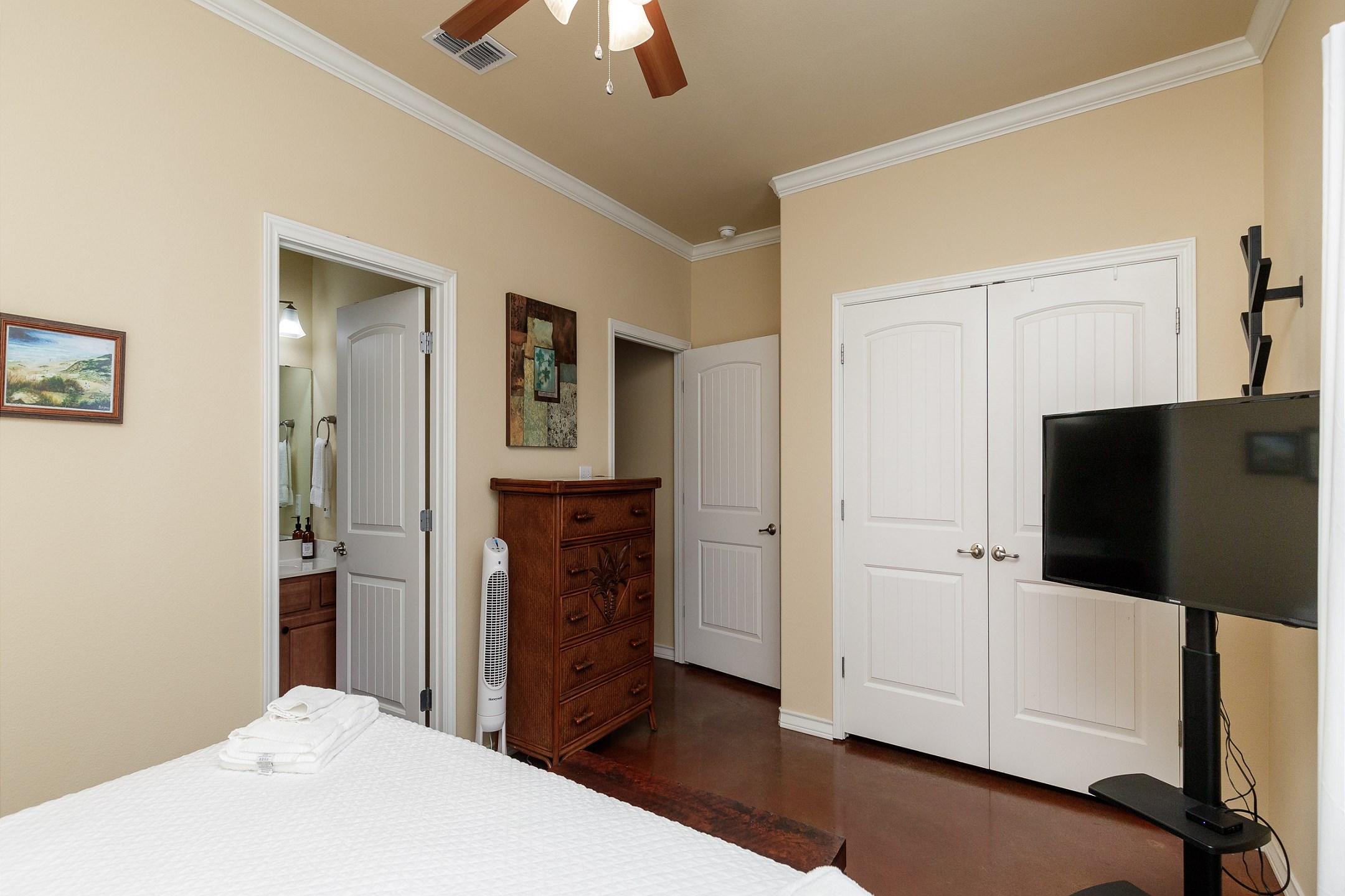 Master bedroom with king size bed, private bathroom, and TV
