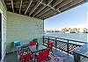 Living area balcony with cozy seating an beautiful water views 