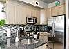 Fully equipped kitchen with stainless steel appliances and beautiful counter tops 