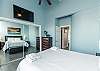 Master bedroom with queen size bed, private balcony and flat screen TV
