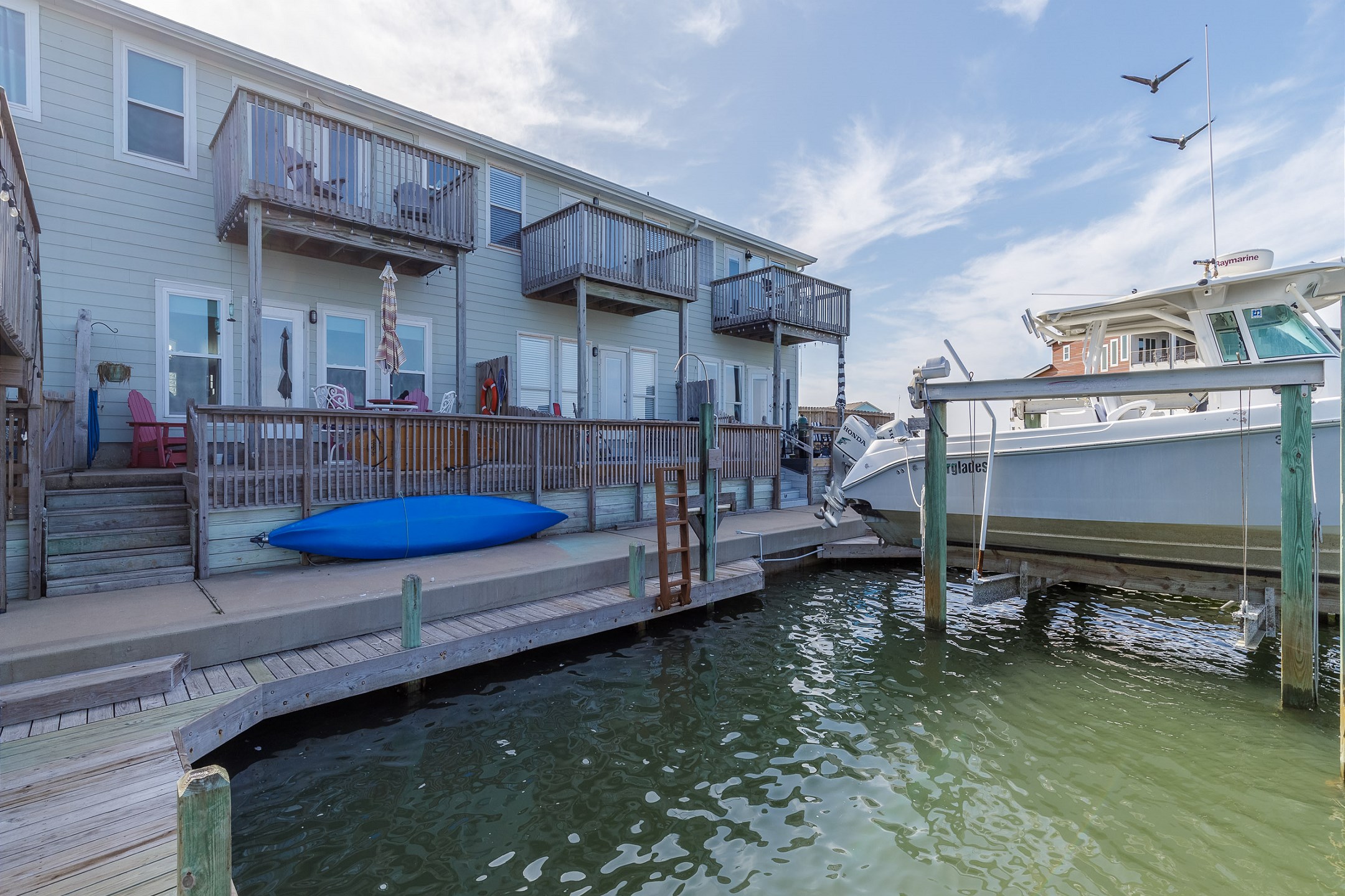 Back view of property showing the downstairs deck and upstairs balcony (canoe not included)