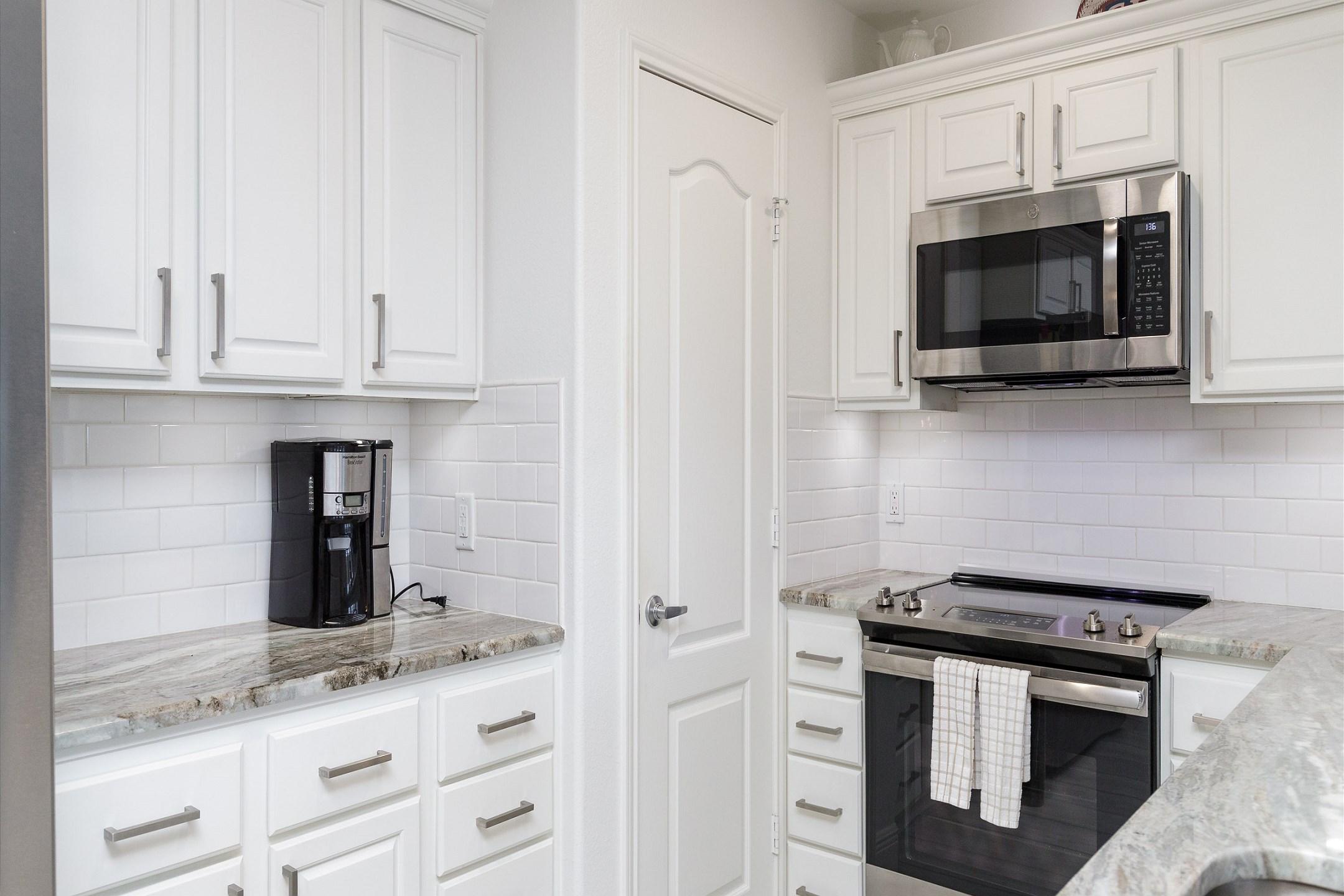 Fully equipped, elegant kitchen area with stainless steel appliances and 12-cup coffee maker 