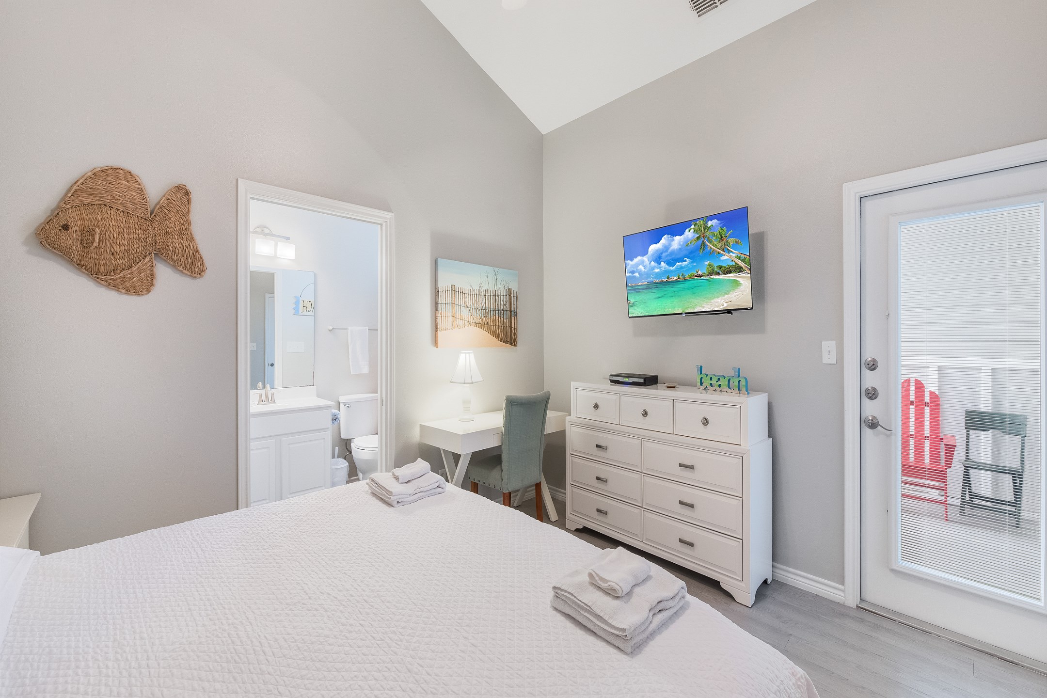 Master bedroom with king size bed, private bathroom, flat screen TV and workspace