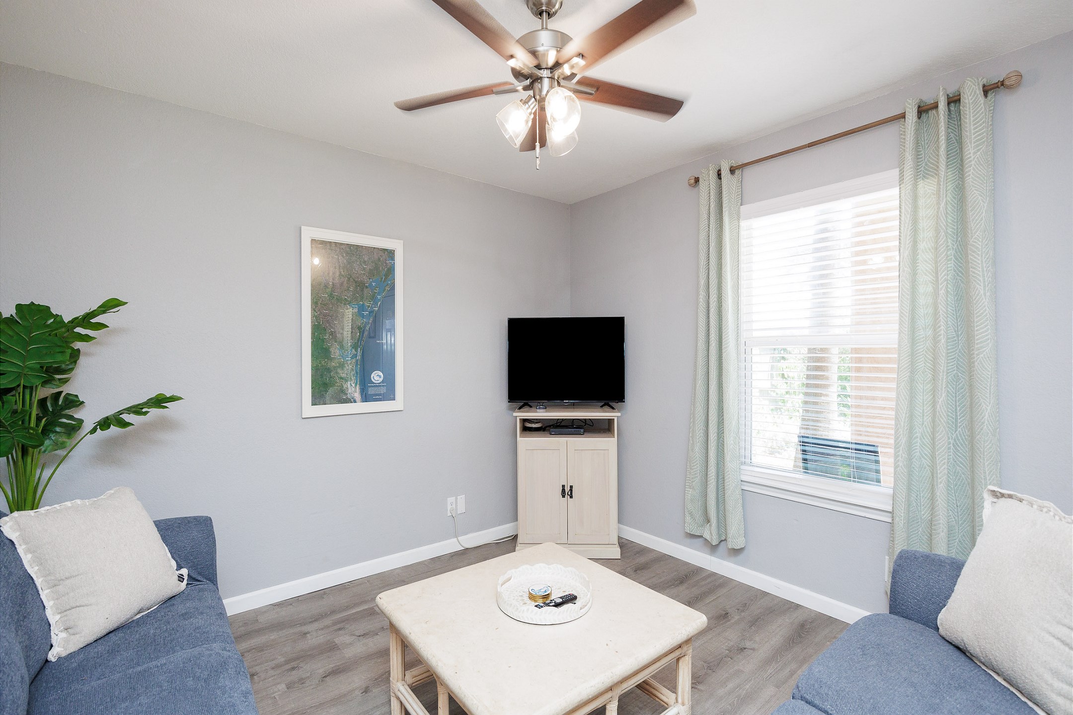 Bright living area with a flat screen TV and lots of natural light 