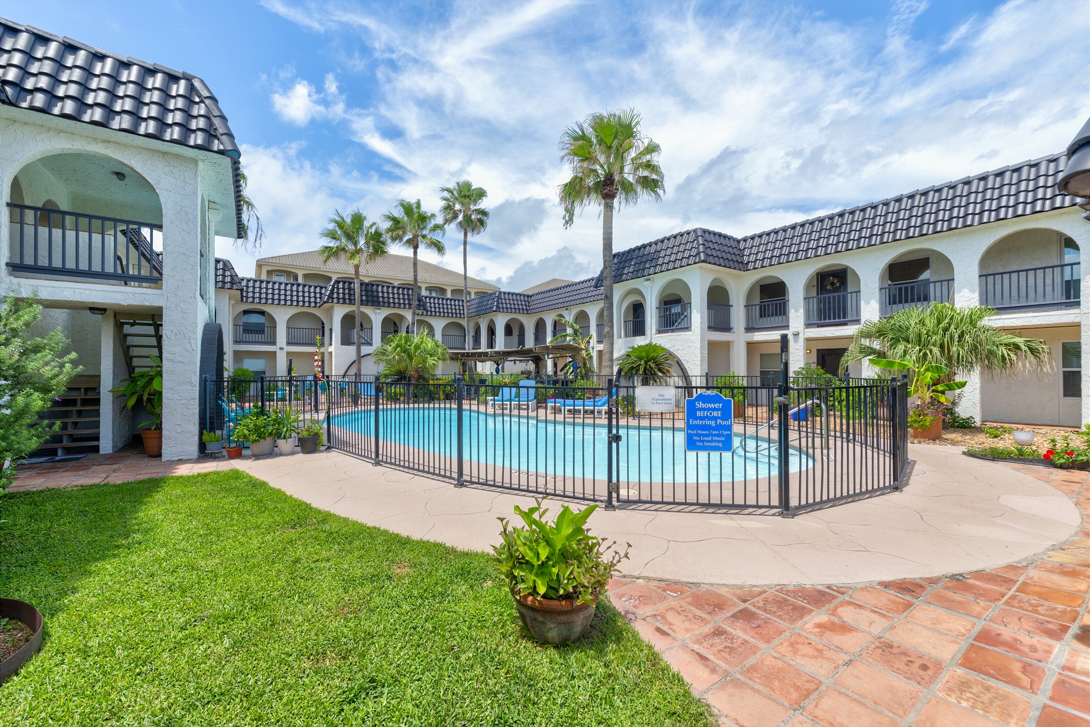 Family-friendly community fenced in pool with beautiful palm trees surrounding for that tropical feel
