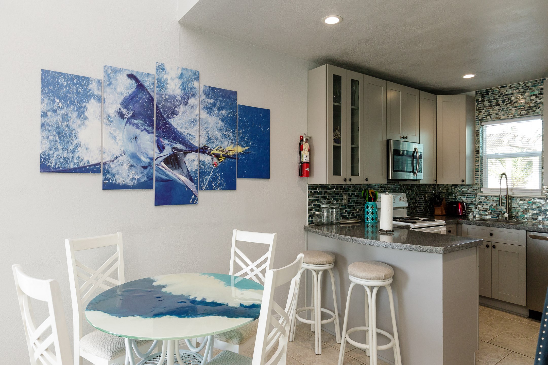 Dining table with seating for four and breakfast bar with seating for two displaying the custom made dining table top