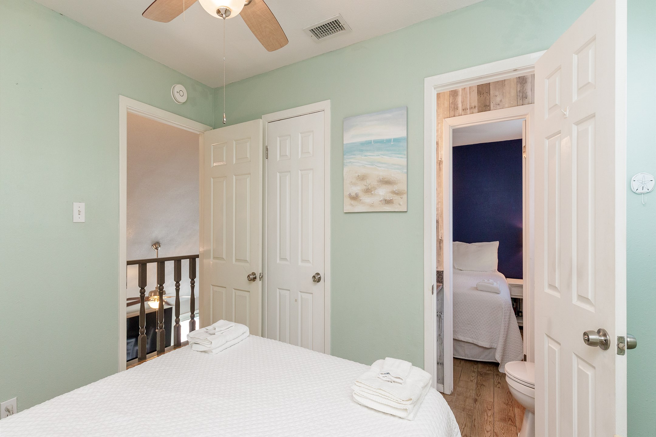 Guest bedroom on the second floor with queen size bed and half bathroom
