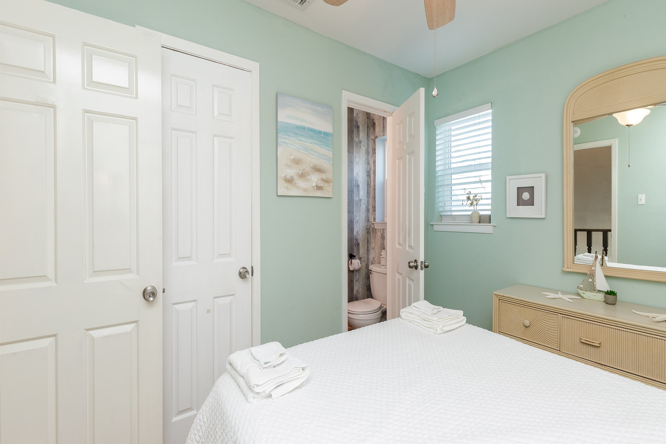Guest bedroom on the second floor with queen size bed and half bathroom