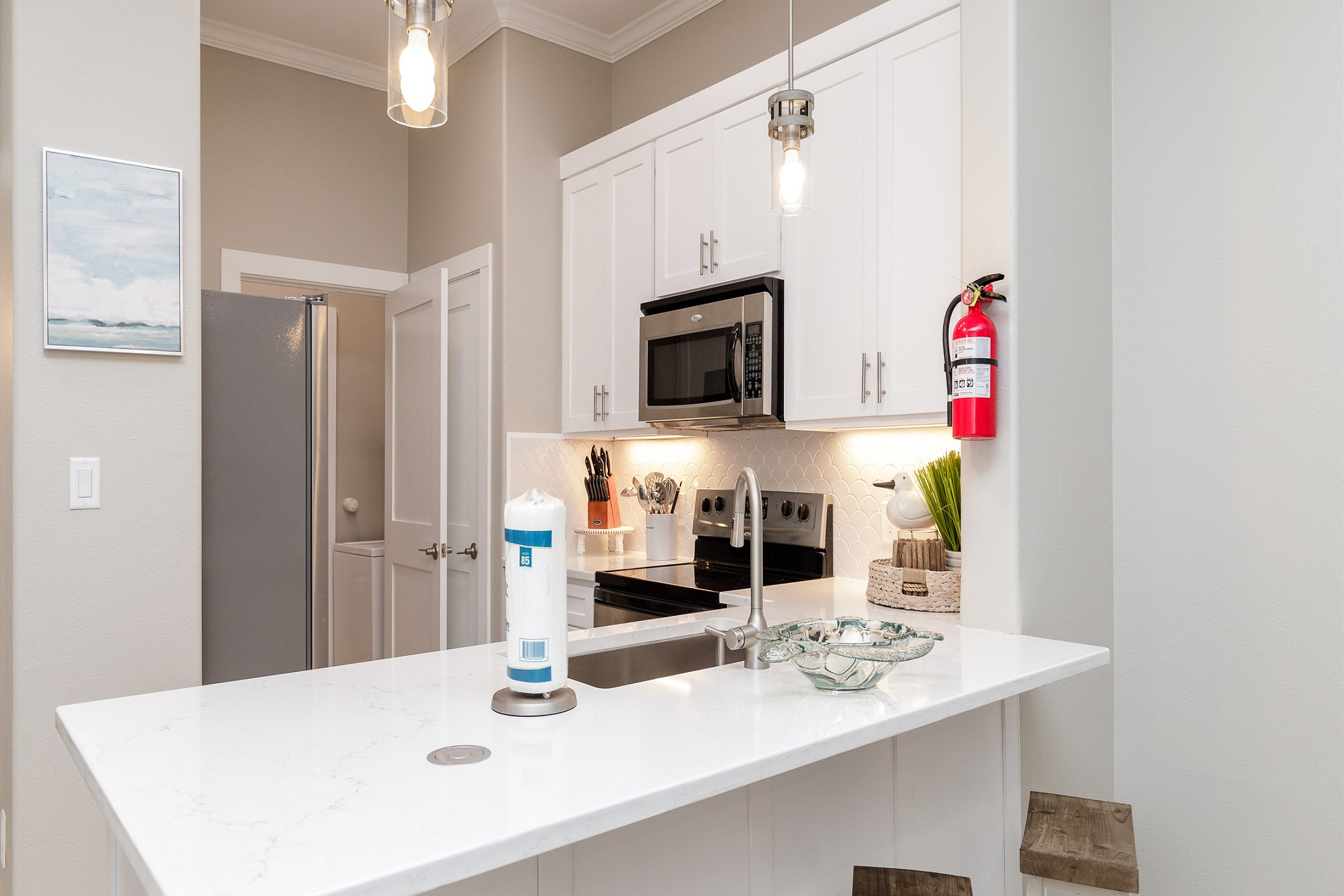 Kitchen area and breakfast bar that seats three