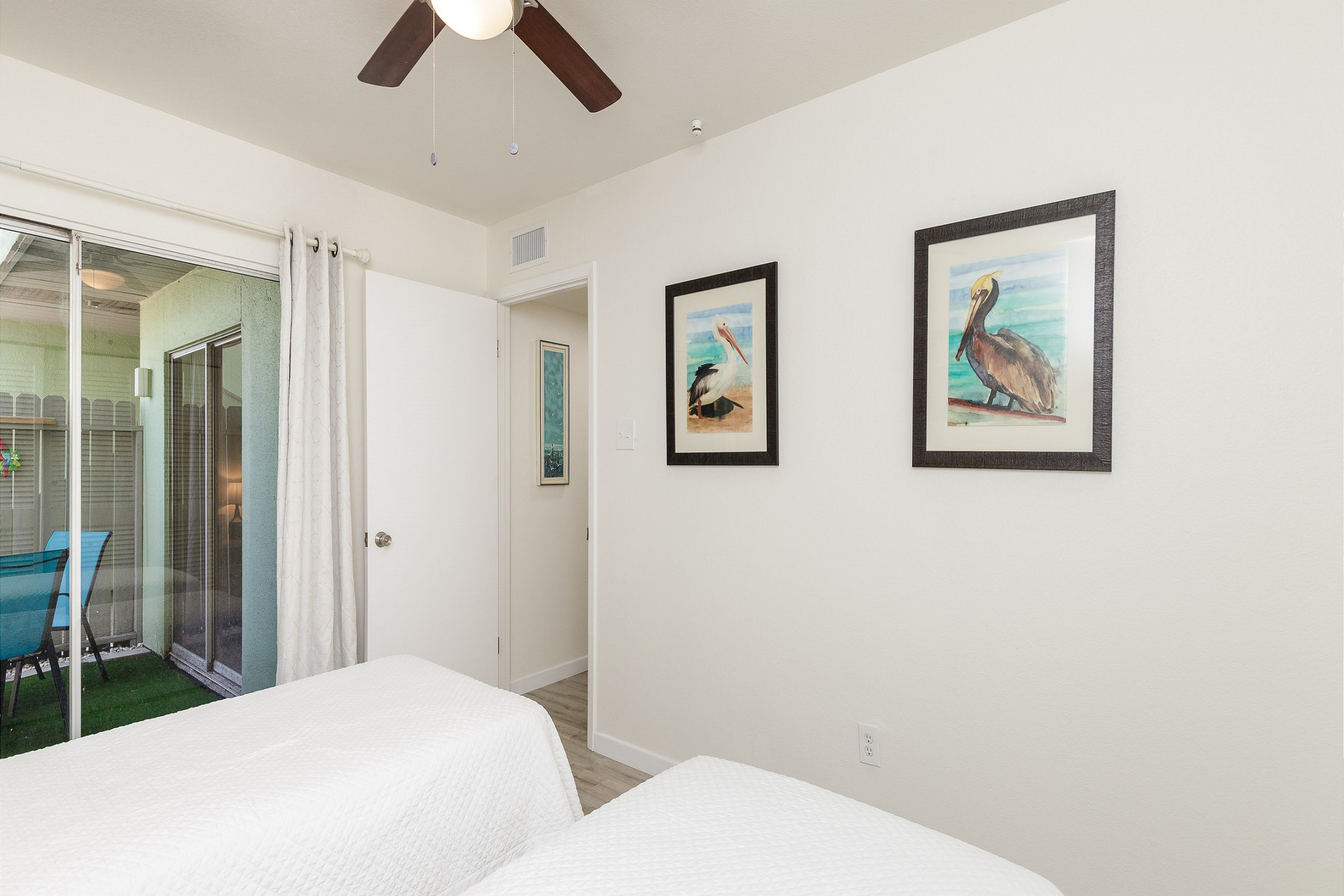 Third bedroom with two twin size beds and access to the shared patio space