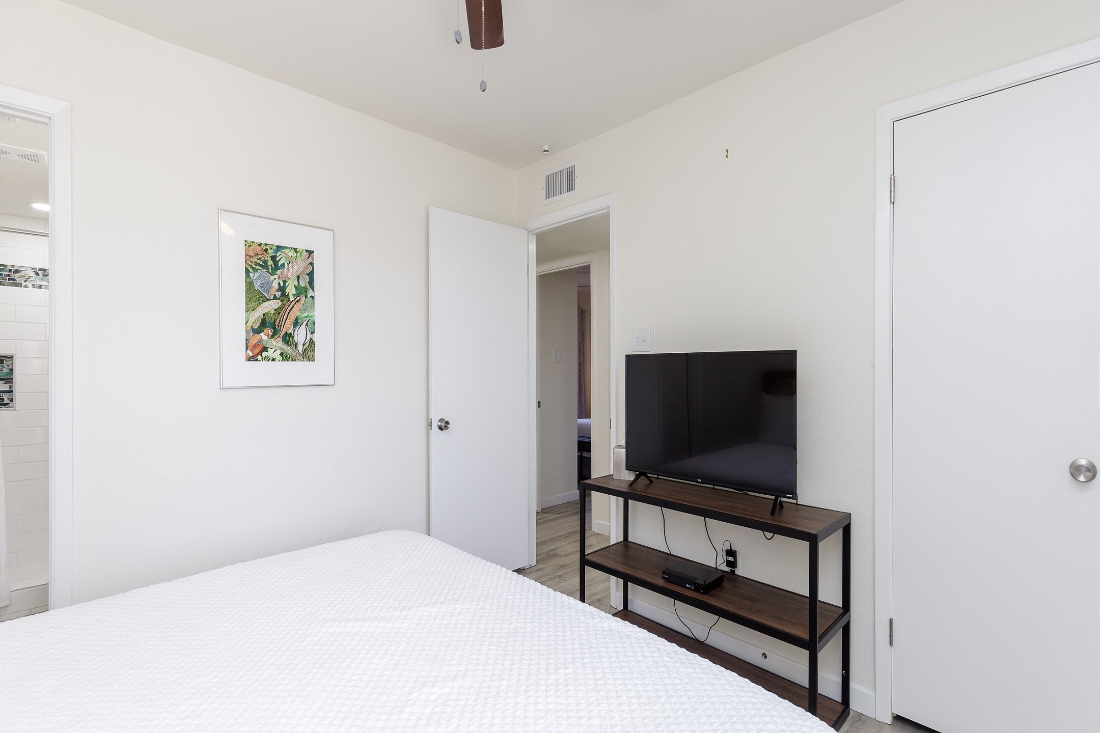 Master bedroom with king size bed, private bathroom, access to patio and flat screen TV