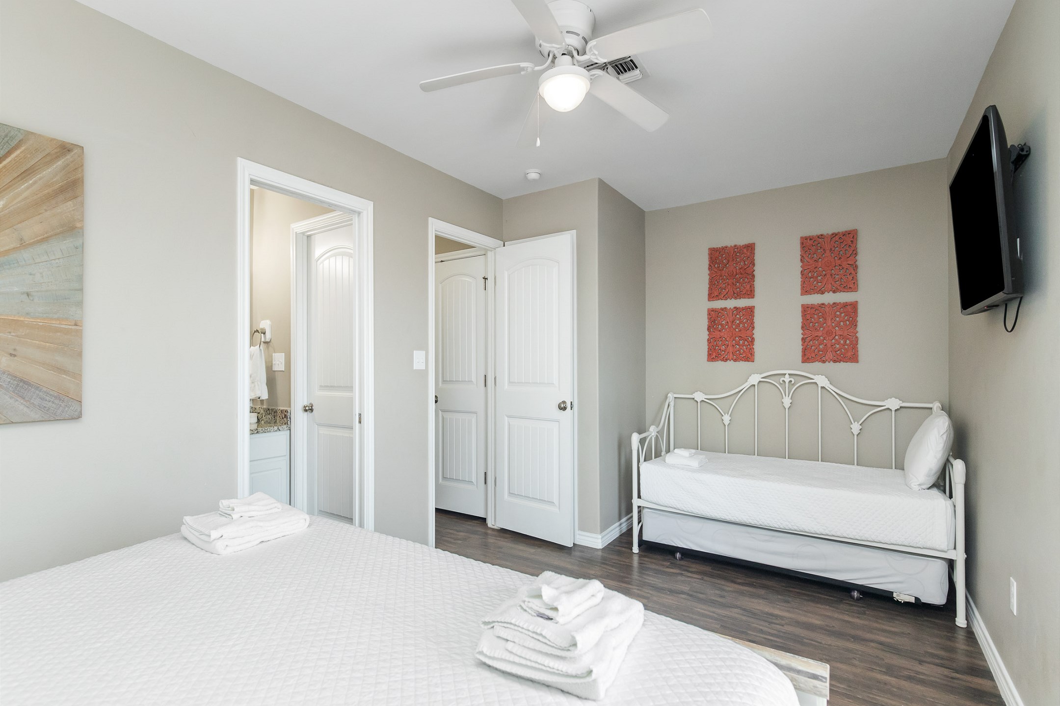 Master bedroom on the first floor with king size bed, twin day bed and twin trundle, access to private patio, private bathroom and flat screen TV