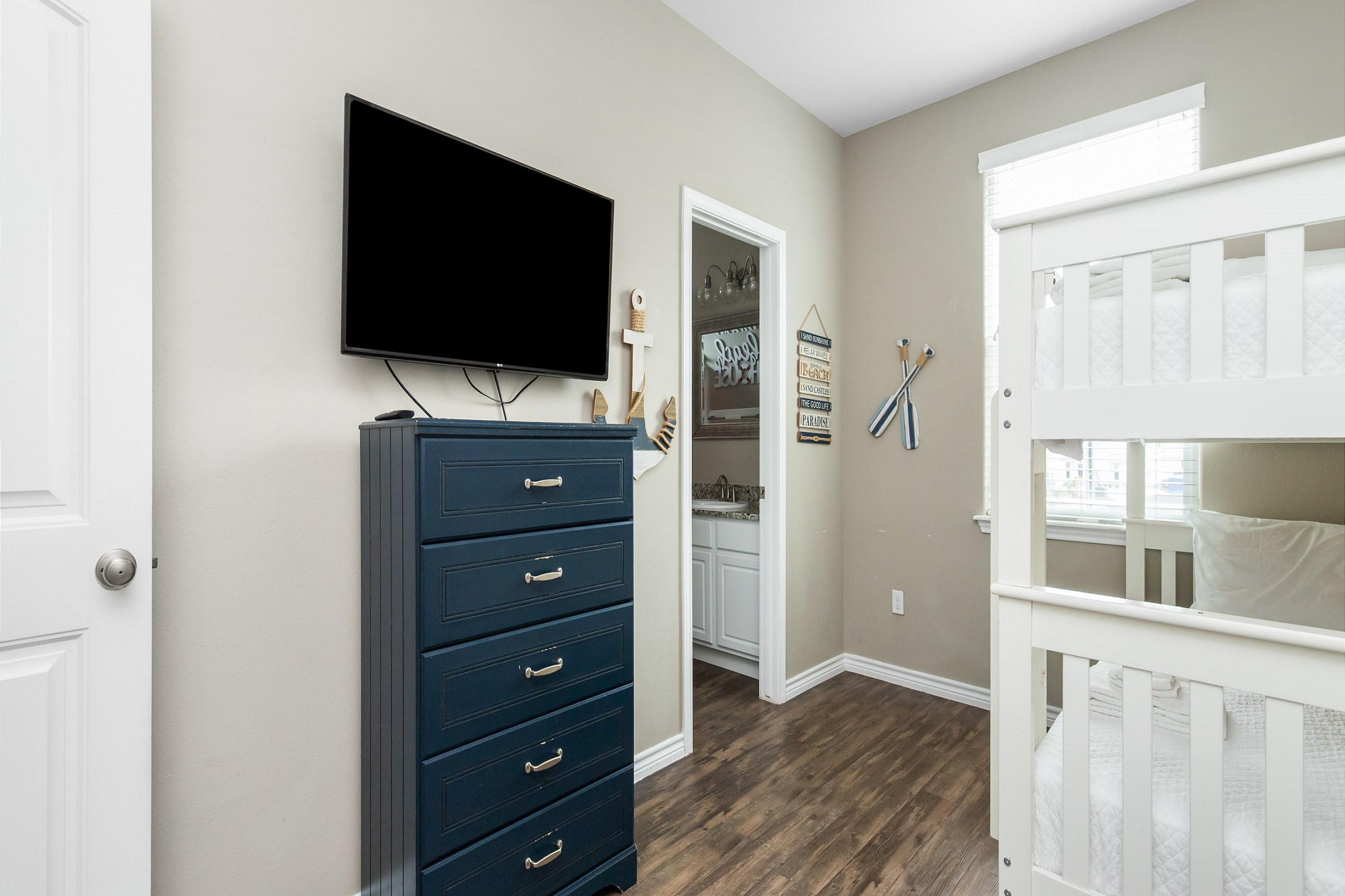 Fourth bedroom on the second floor with twin over twin size bunk bed, shared bathroom and flat screen TV