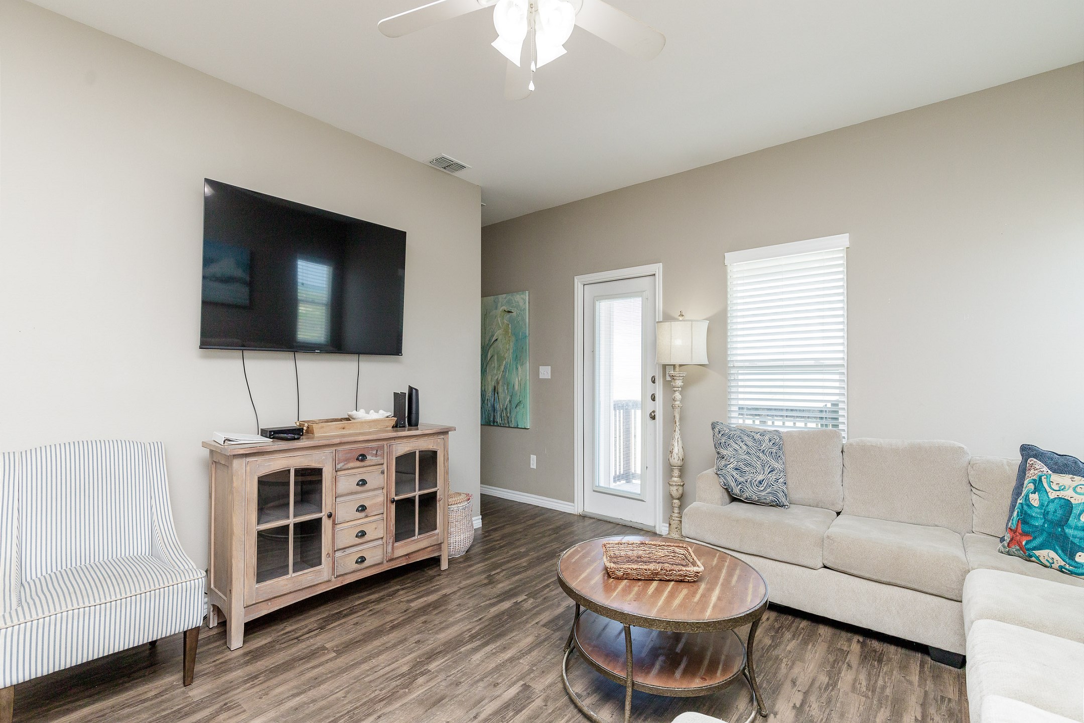 Cozy living space with queen size sleeper sofa, flat screen TV and access to private balcony on the third floor 