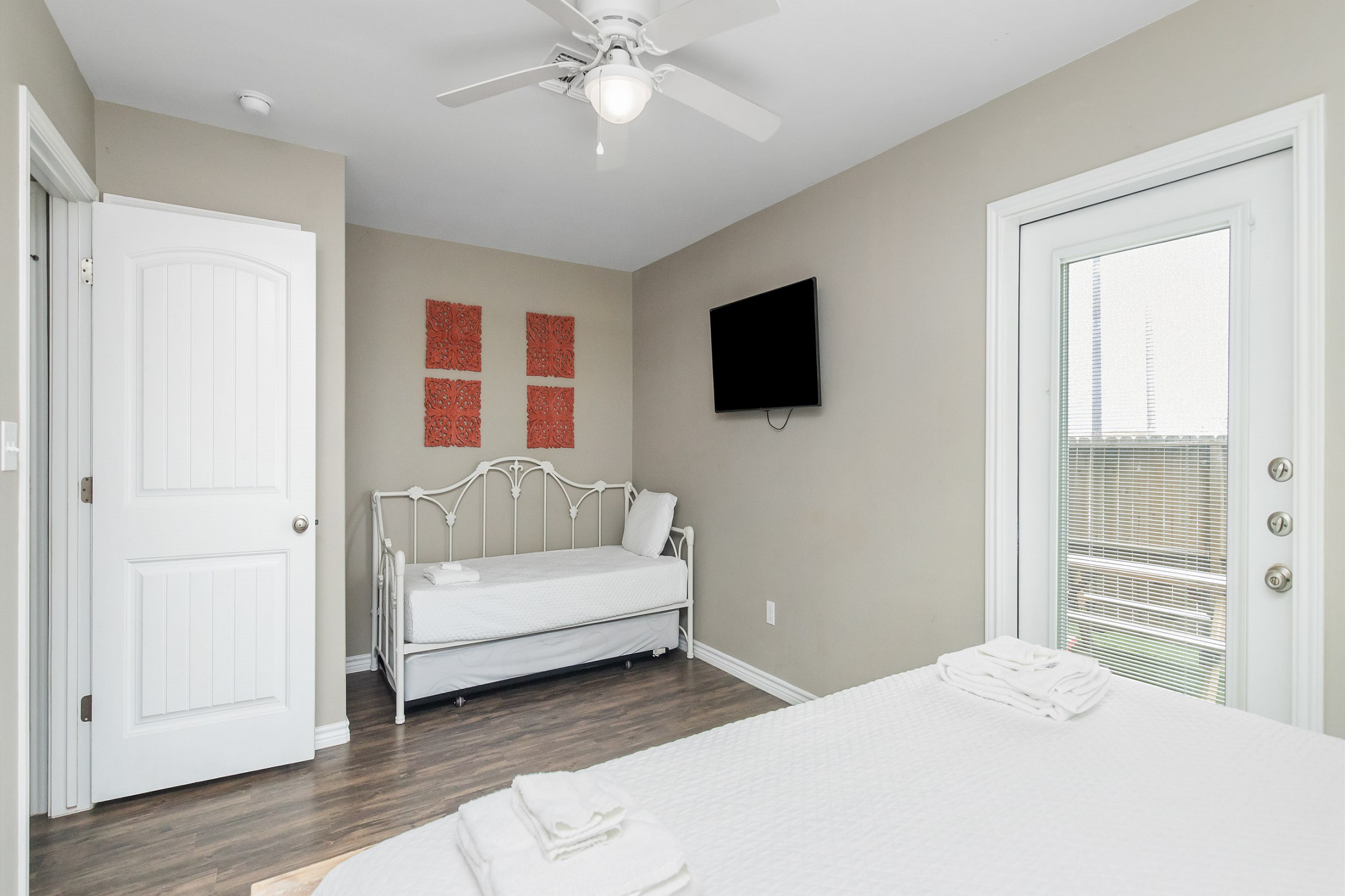 Master bedroom on the first floor with king size bed, twin day bed and twin trundle, access to private patio, private bathroom and flat screen TV