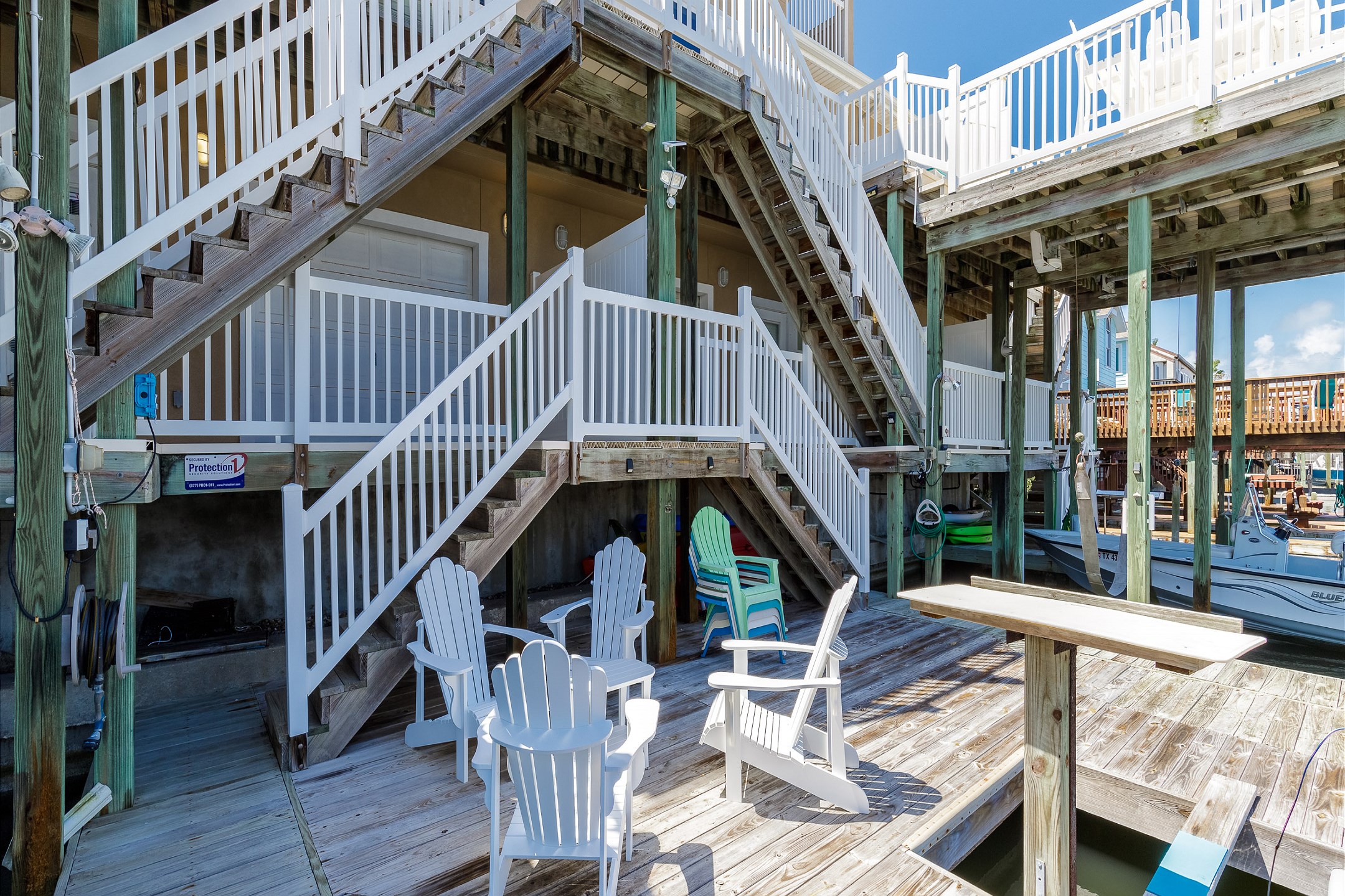 Lower level of private deck with comfy chairs to enjoy the water views (outside water equipment not for guests use)