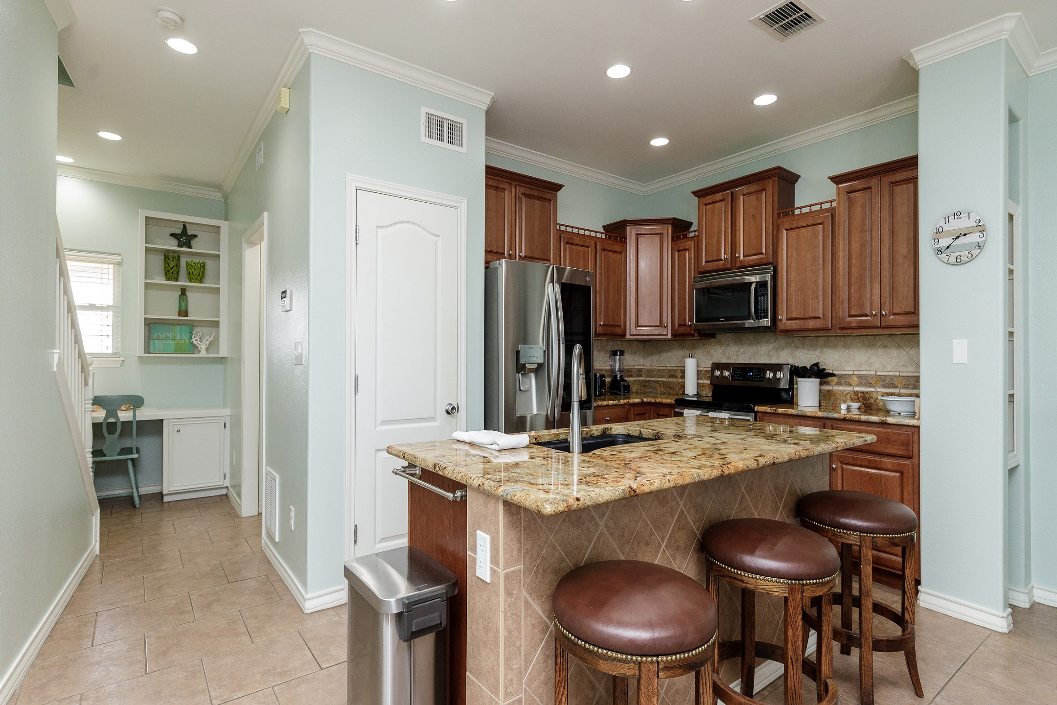 Fully equipped kitchen with stainless steel appliances and large Island