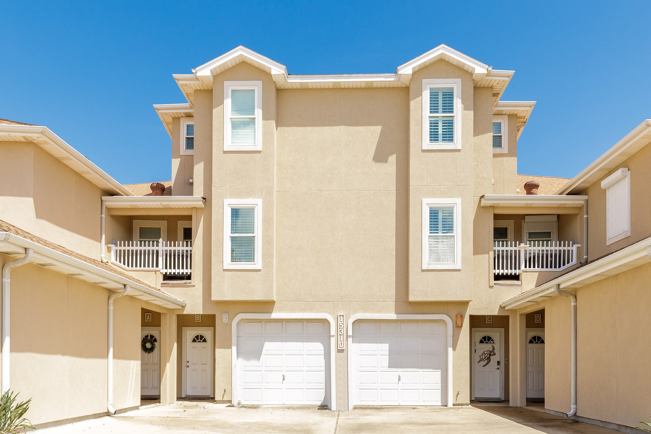 Front view of property entrance with garage access