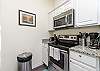 Fully equipped kitchen with stainless steel appliances and coffee maker 