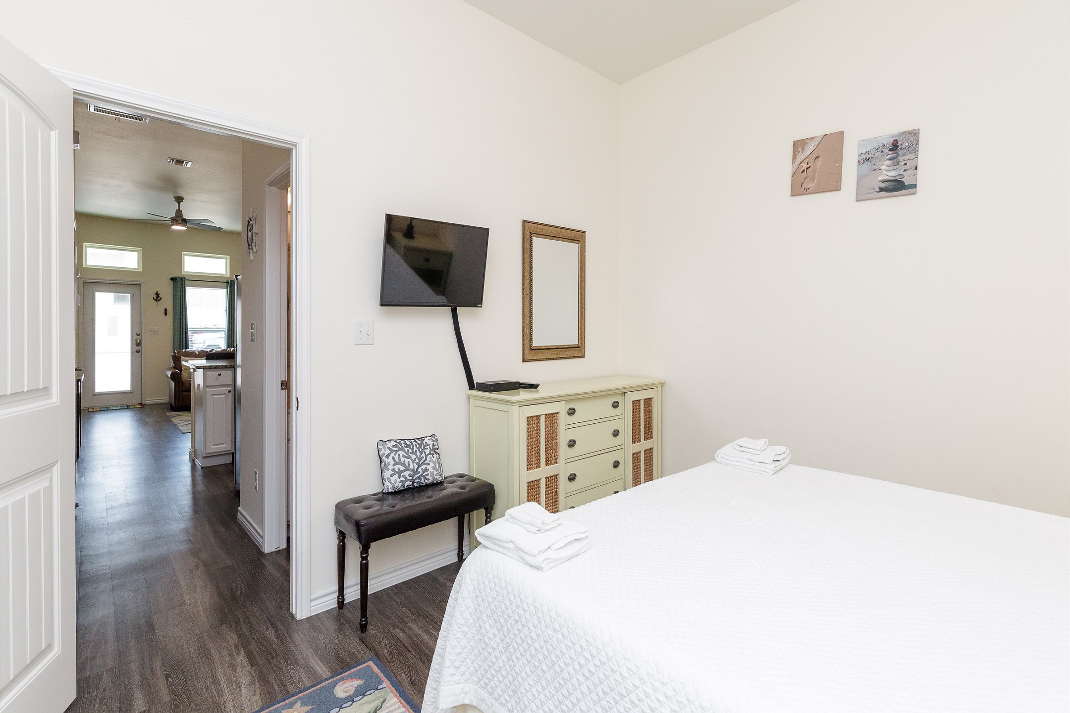 Master bedroom with king size bed and mounted TV