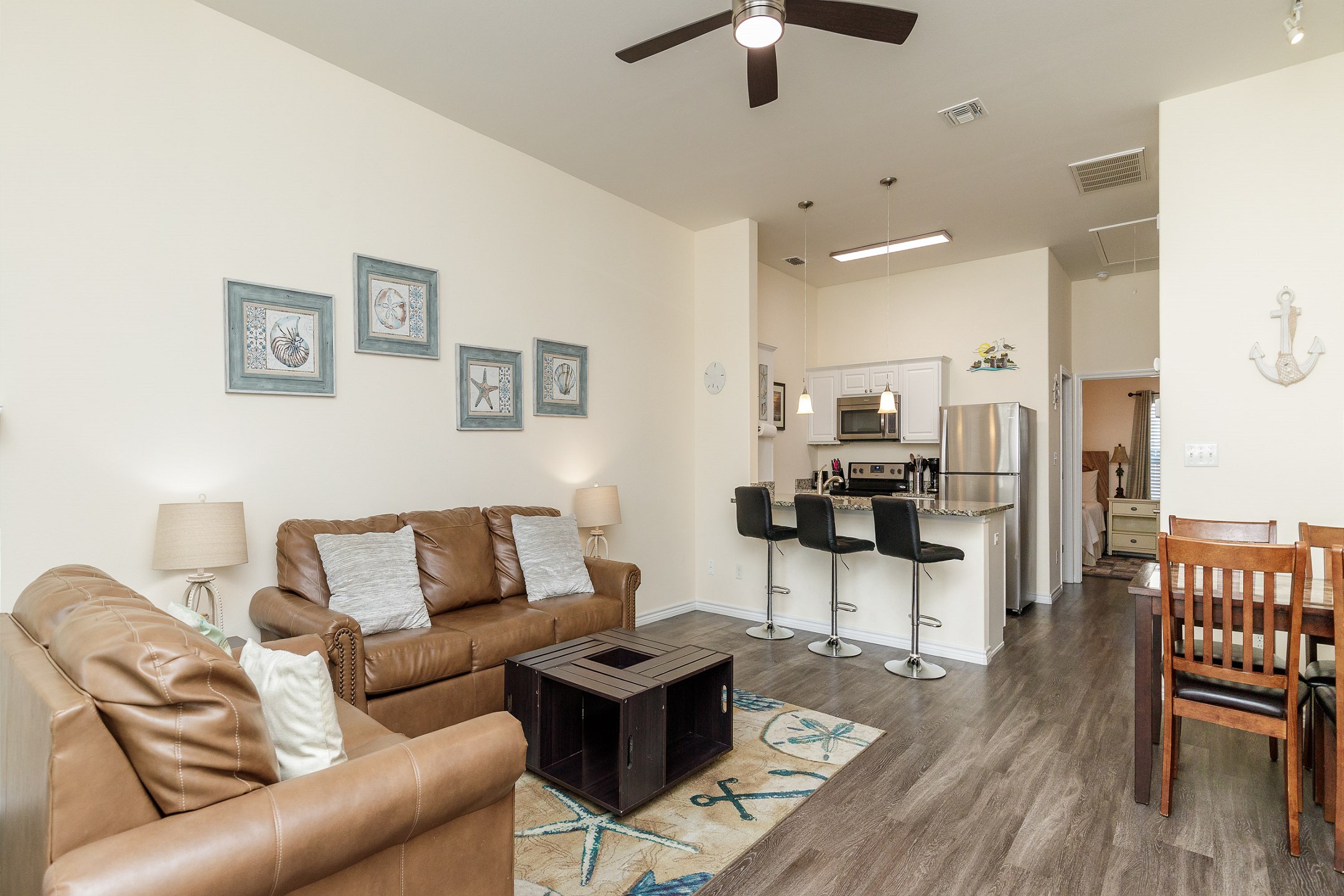 Expansive social hub with a well-equipped kitchen, dining table, and cozy living room