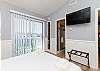 Master bedroom with queen size bed, private balcony and privacy wall that opens and closes