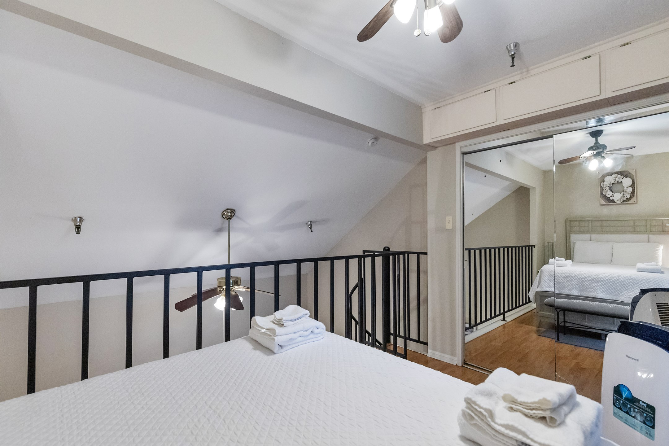 Loft space on the second floor with queen size bed, flat screen TV and private balcony 
