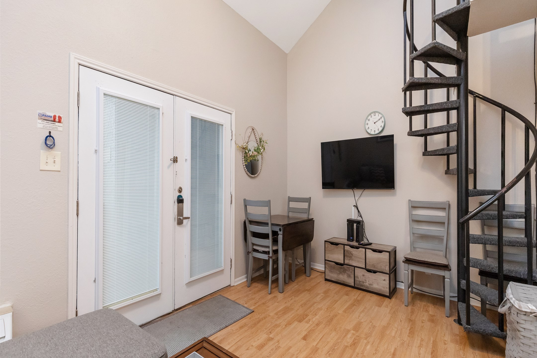 Living space with dining table that seats three and flat screen TV to enjoy
