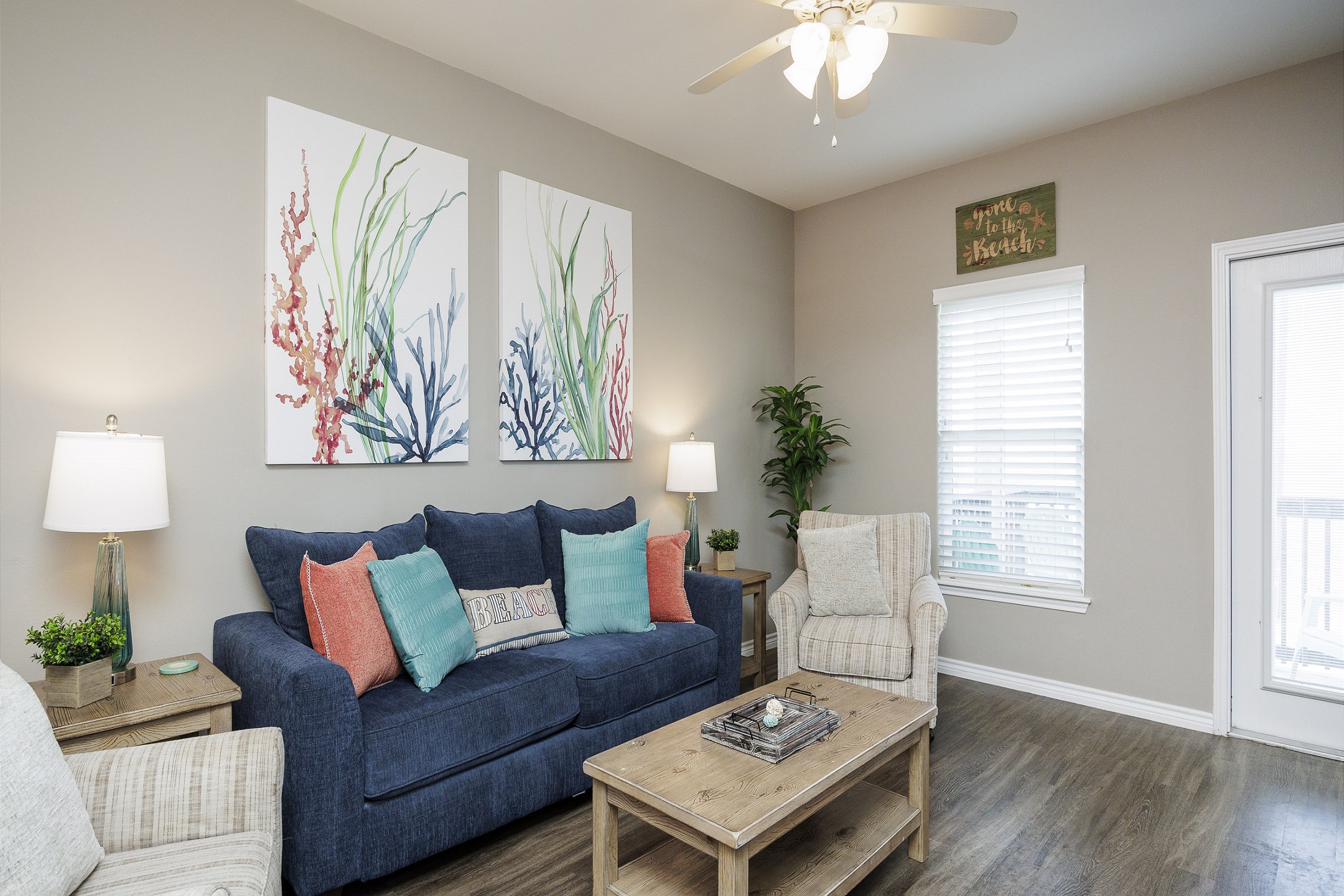 Living area on the second floor with queen size sleeper sofa and access to the private balcony