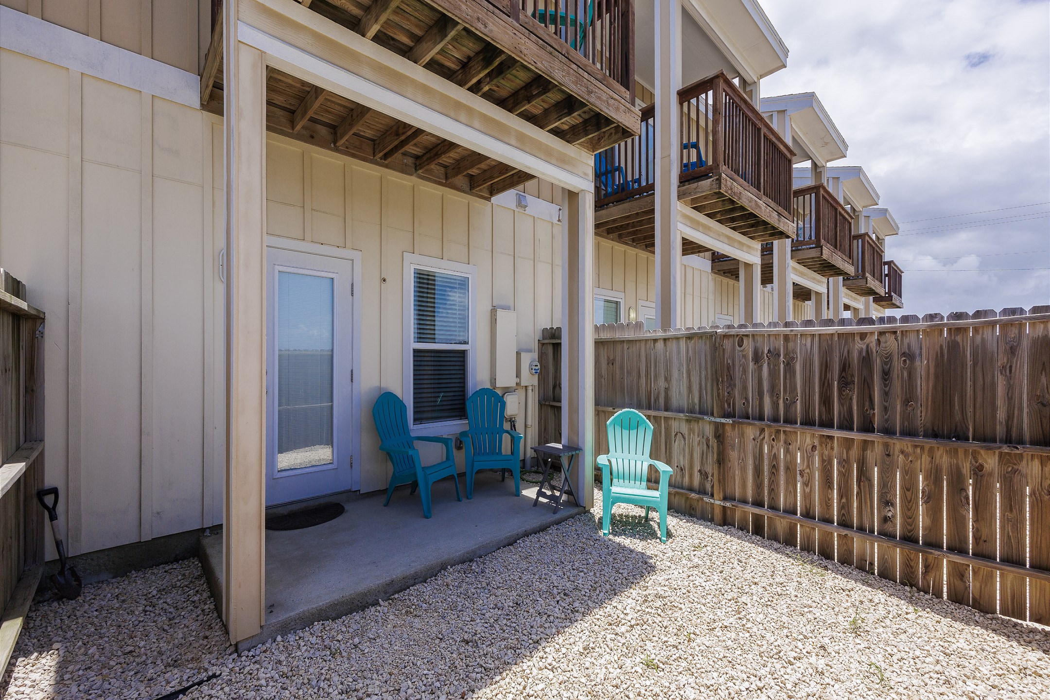 Private fenced in patio with chairs off the master bedroom