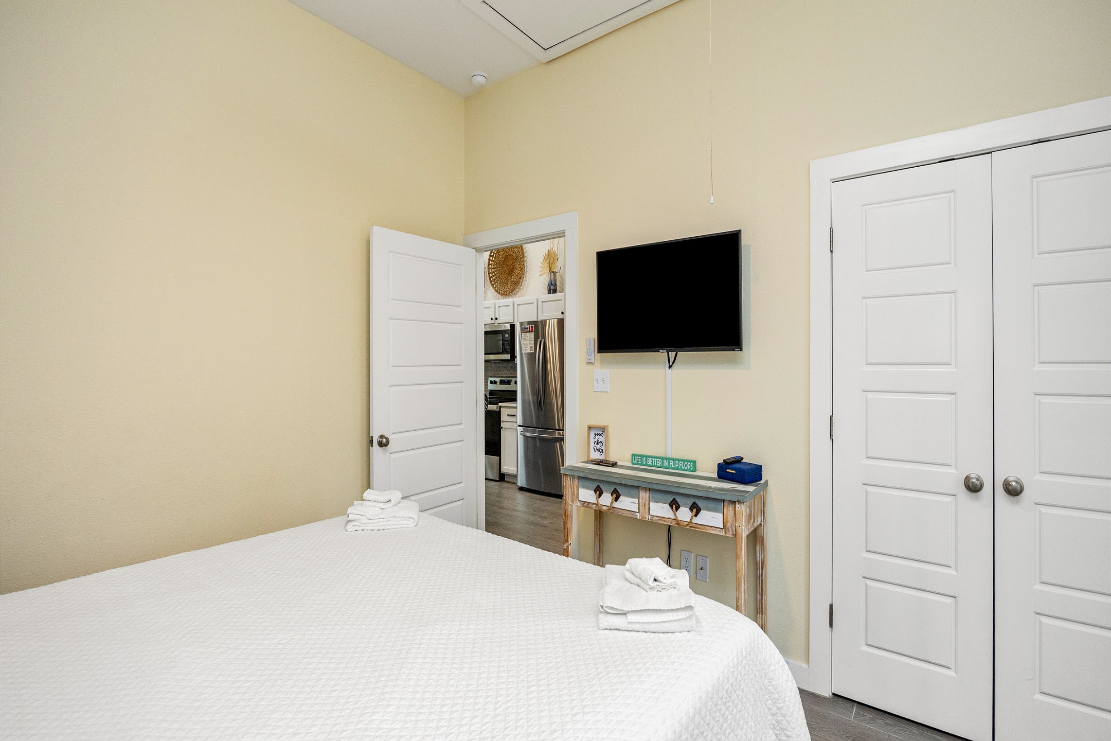 Master bedroom with king size bed, back patio access, and flat screen TV