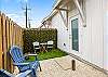 Charming back patio with rock and turf grass, perfect for relaxing or entertaining