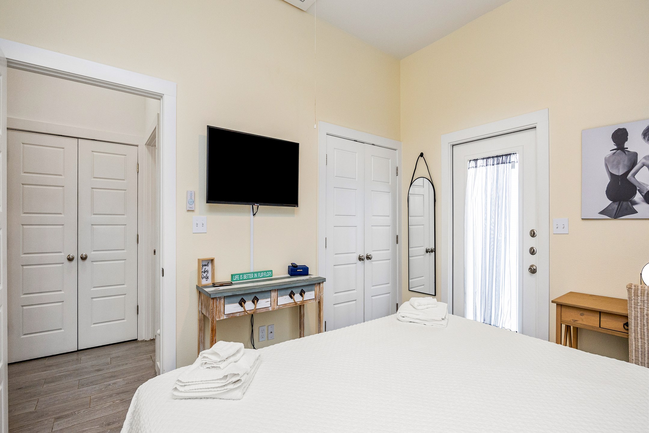 Master bedroom with king size bed, back patio access, and flat screen TV