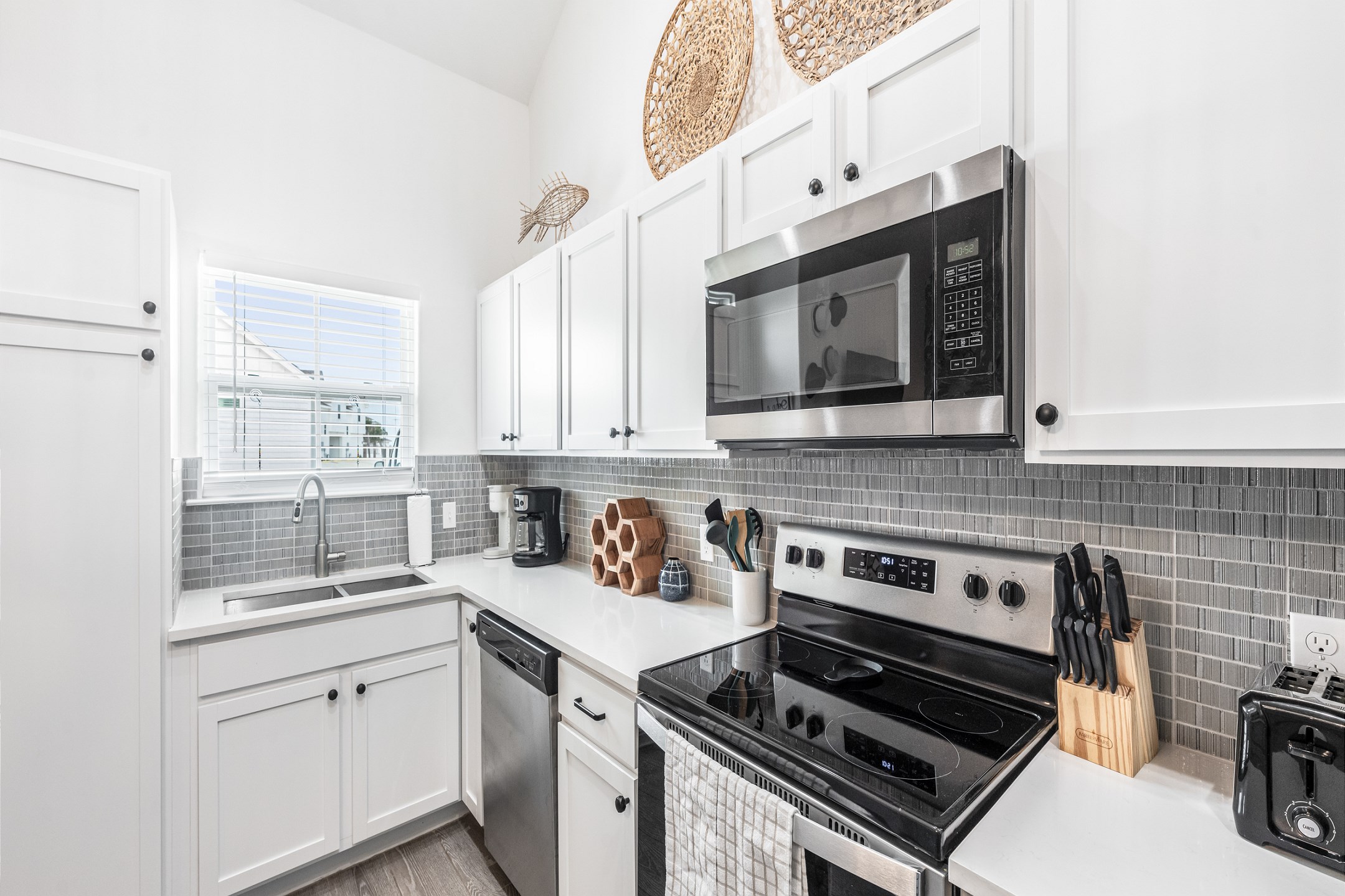 Fully equipped kitchen with stainless steel appliances and coffee maker