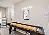 Shuffle board in the living area perfect for family game nights 