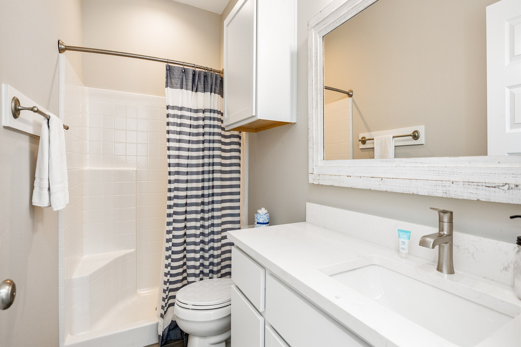 Guest bathroom on the first floor with single sink and walk in shower