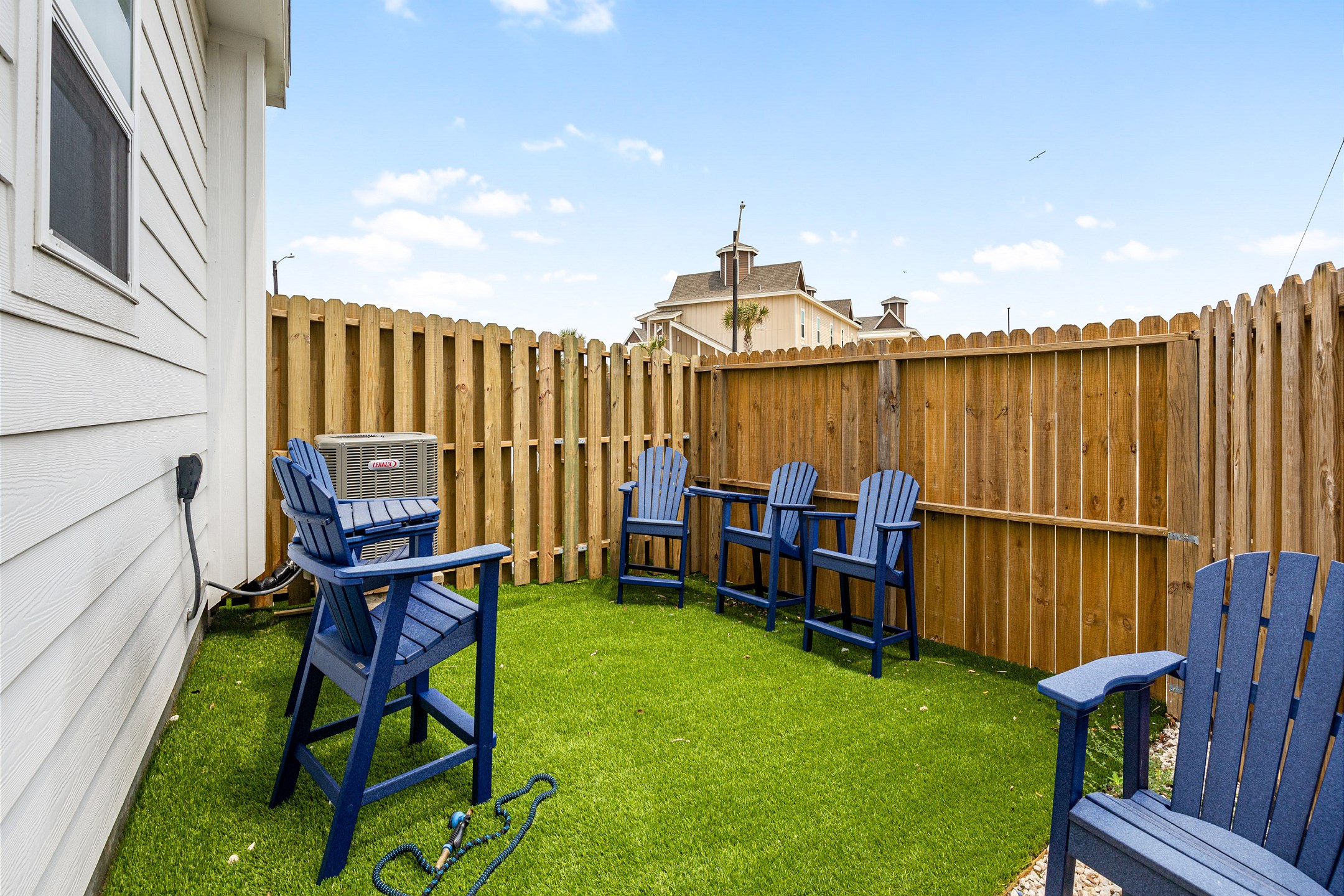 Private turf patio with seating, perfect area for sun bathing or entertaining 