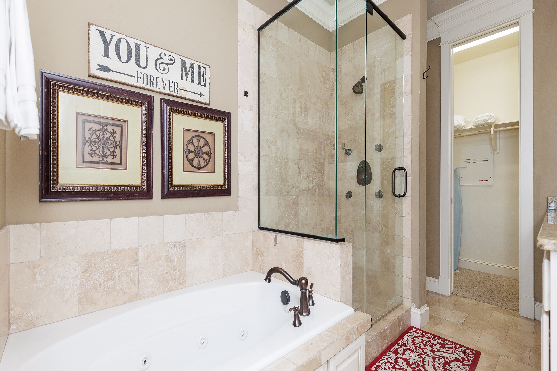 Master bathroom on the second floor with walk in shower, tub, double sinks and walk in closet