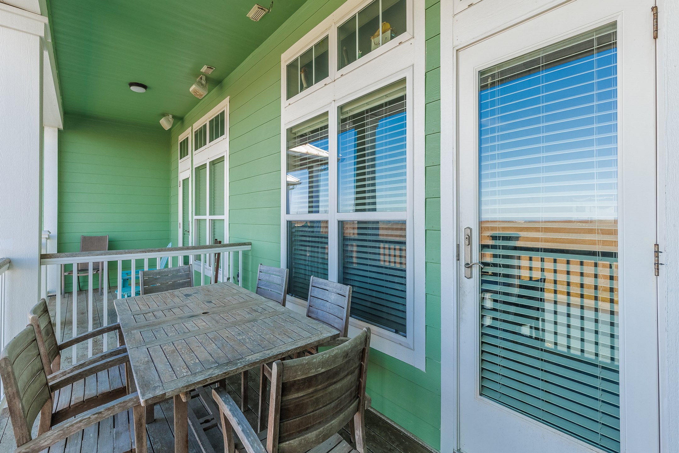 Relax and unwind with cozy outdoor seating on the private balcony overlooking the water