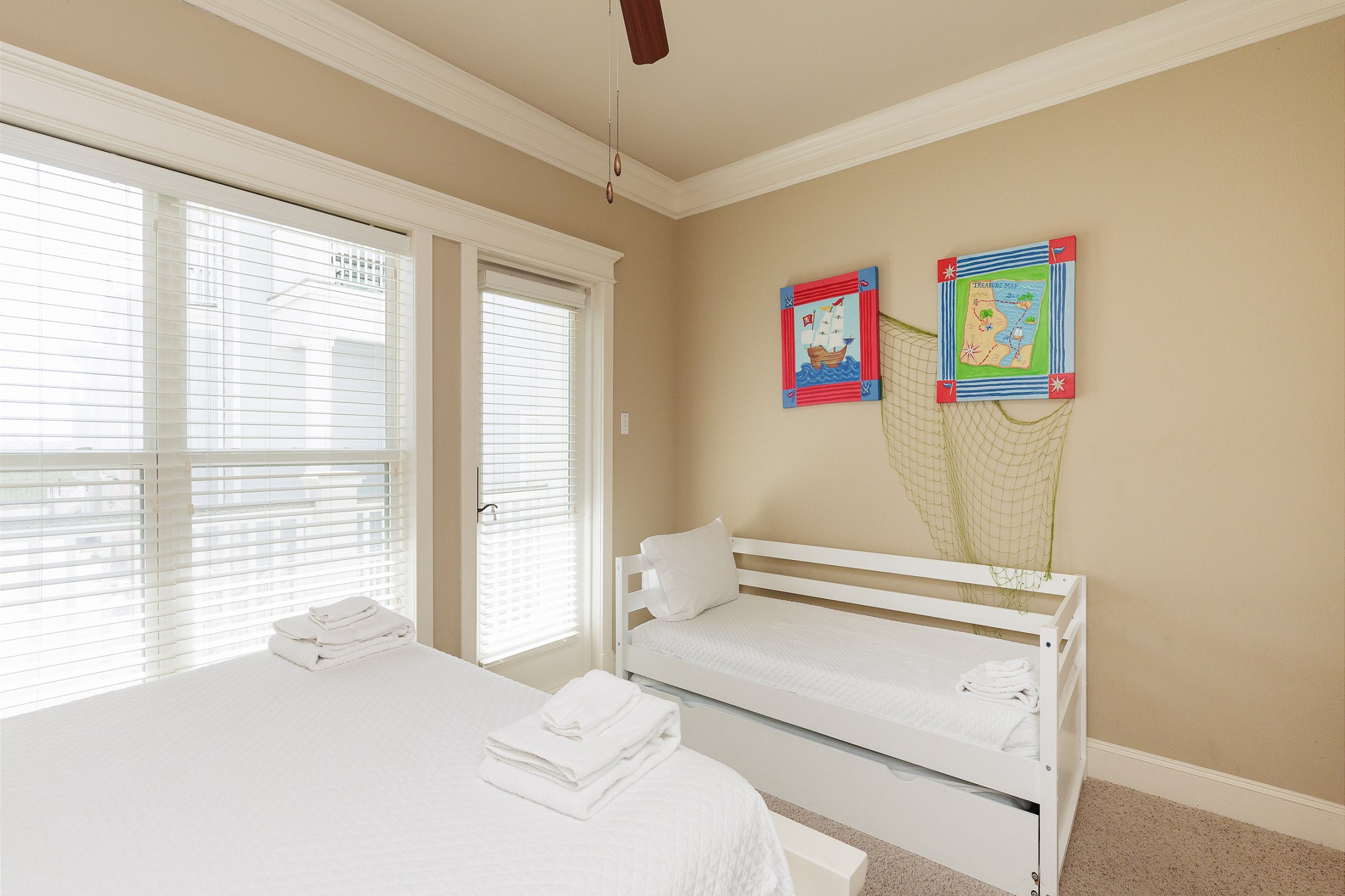 Second bedroom on the second floor with queen size bed, twin daybed with twin trundle and private balcony 