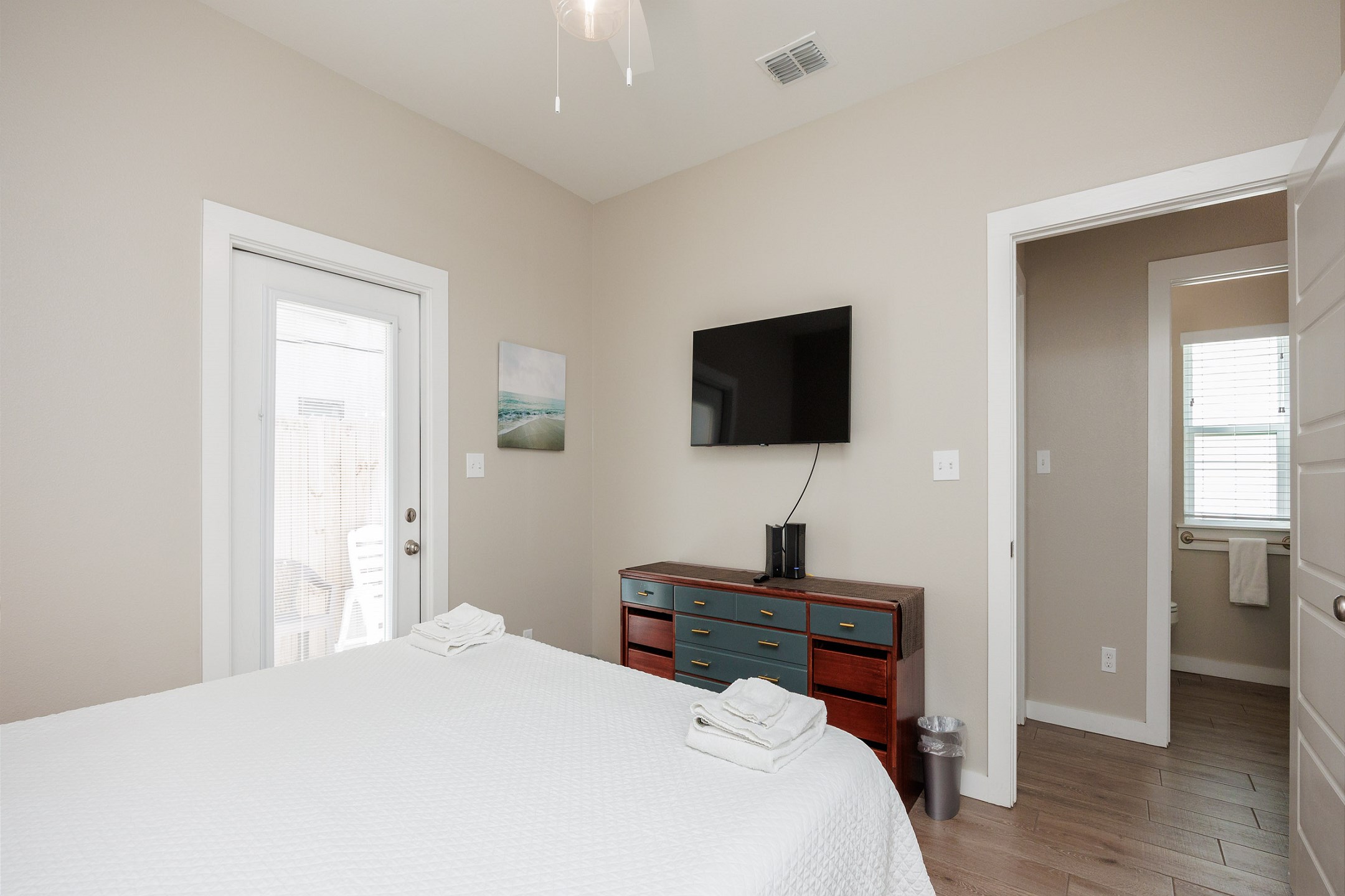 Unwind in the master retreat with a king-size bed with private patio access-perfect for laid-back vacation vibes.