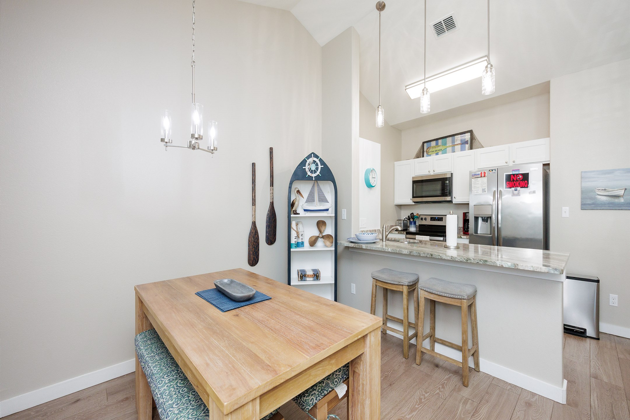 Fully equipped kitchen with a convenient breakfast bar and a charming rustic wooden table with a natural finish