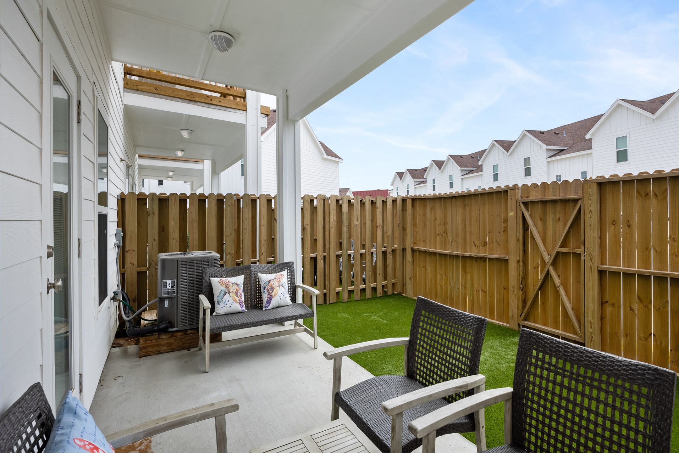 Private patio space with turf grass for you and your guests to enjoy