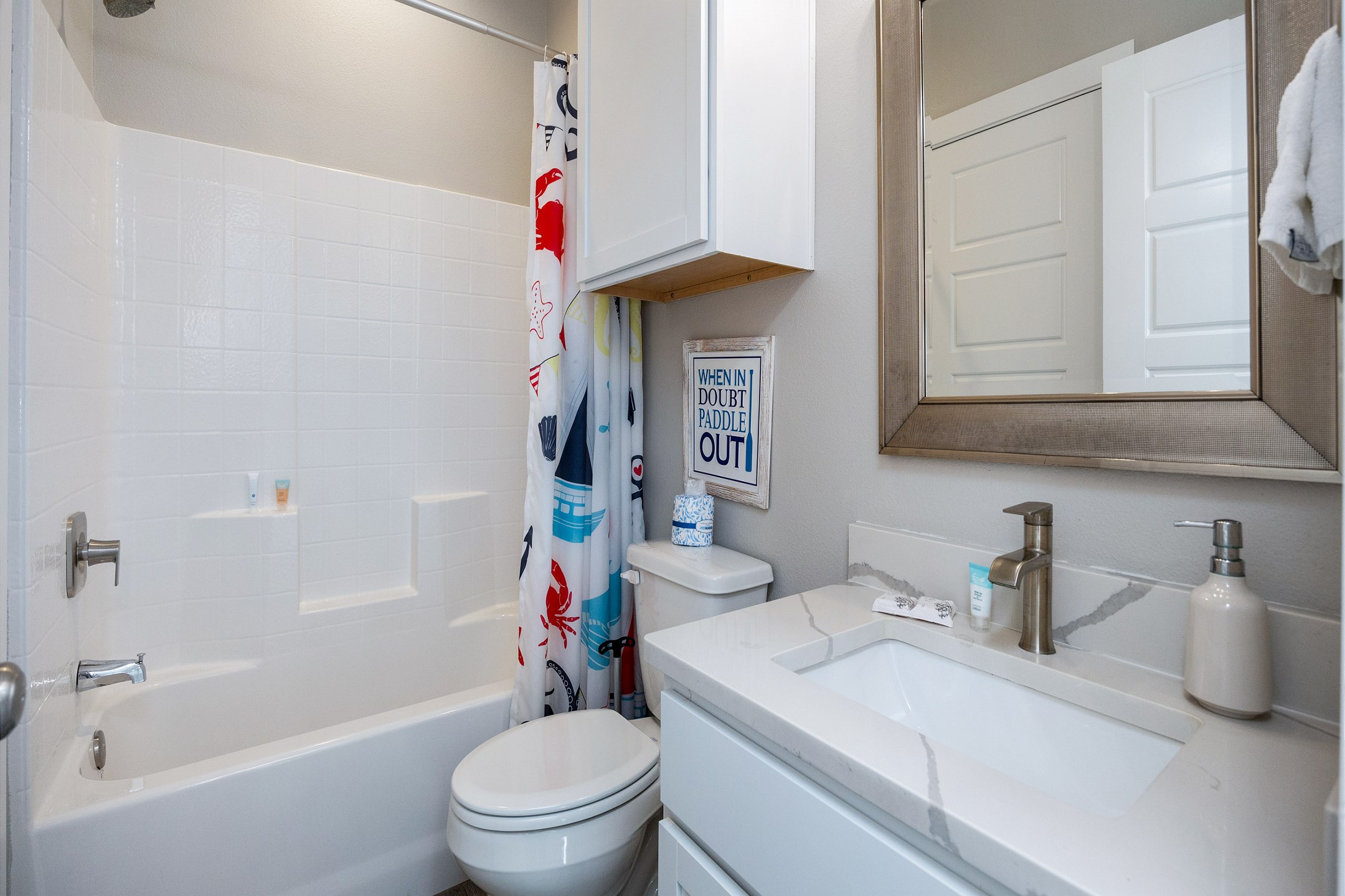 Guest bathroom on the second floor with sink, toilet, and tub/shower combo 