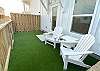 Back patio area with turf and relaxed seating 