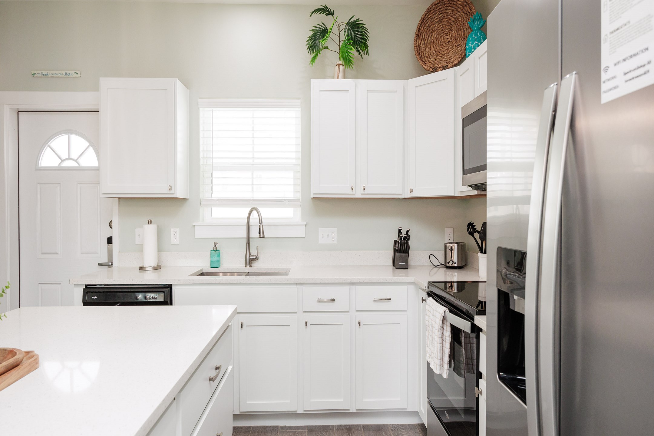 Bright kitchen with granite countertops and plenty of space designed for full meal preparation