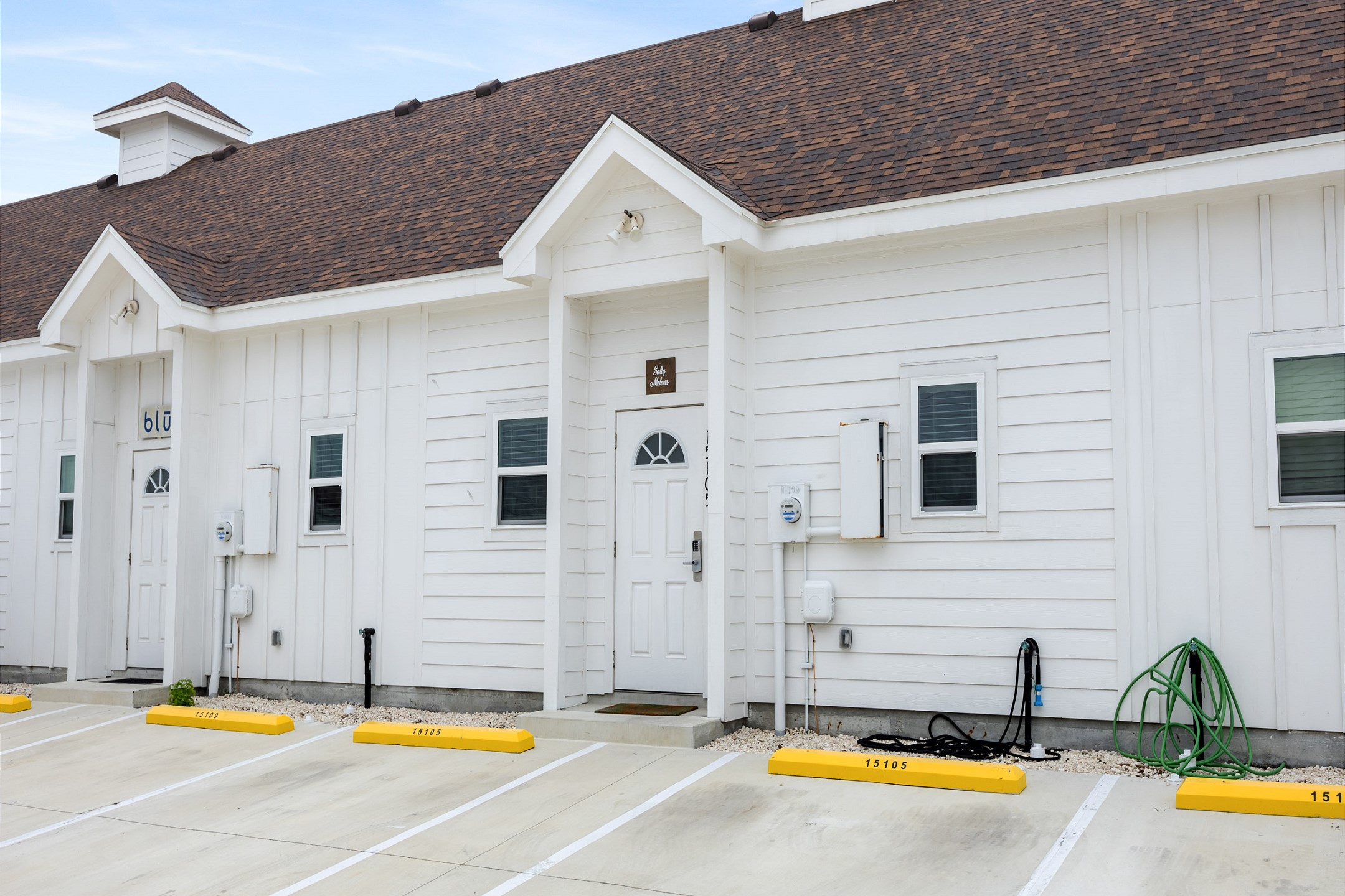 Exterior of property with two assigned parking spaces 